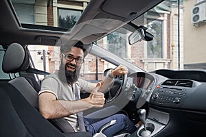 Man driver happy smiling showing thumbs up driving sport car