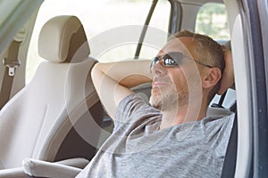 Man is resting in the car