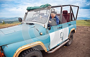 Man drives allterrain car vehicle on offroad safari tour of African national park, Extreme tour on passable ATV