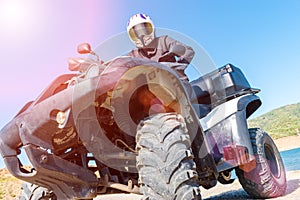 A man is driving ATV on off-road.