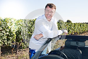 man driving with blue convertible car smiling and happiness