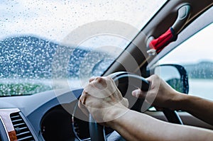 Man is driving a car attentively and carefully in bad weather da