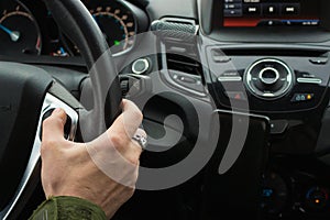 Man driving car. Auto interior. Man hand on steering wheel. Auto dashboard. Journey concept.