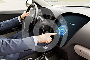 Man driving car with eco mode on board computer