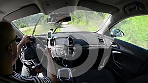 Man driving a car with gps navigation system