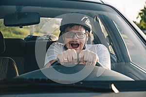 Man driving car in helmet with horror on her face
