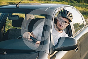 Man driving car in helmet with horror on her face