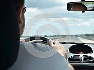 Man driving a car on a highway