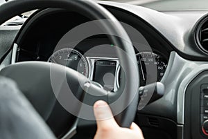 Man driving a car with his hands on the steering wheel