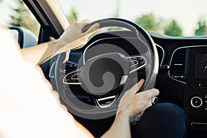 Man driving a car, an image of a man driving a car holding a steering wheel