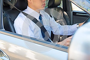 Man driving a car and looking at watch