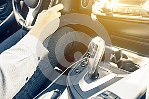 Man driving a car. men`s hands hold the steering wheel