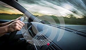 Man driving a car moving fast on a highway