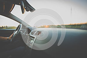 Man driving a car moving fast on a highway