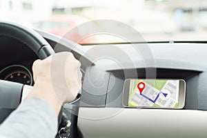 Man driving car and navigating. Mobile app in smartphone. photo