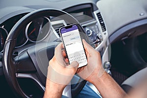 A man driving a car with  phone