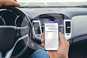 A man driving a car with  phone