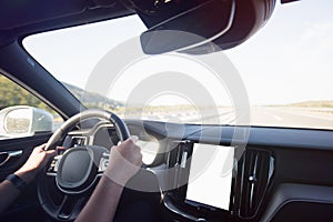 Man driving a car. Success in motion. Handsome young man driving a car. A man holds the steering wheel of a car