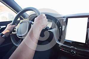 Man driving a car. Success in motion. Handsome young man driving a car. A man holds the steering wheel of a car