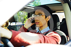 Man driving car and talking on mobile phone