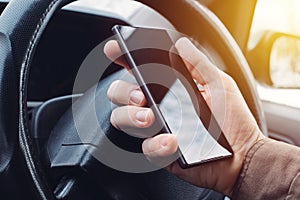 Man driving car and using mobile phone for texting