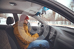 Man driving car using smart phone in car