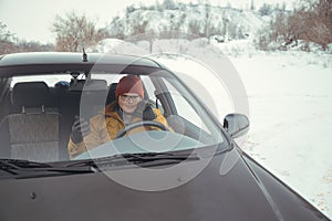 Man driving car using smart phone in car