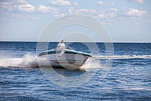 Man driving a fast boat