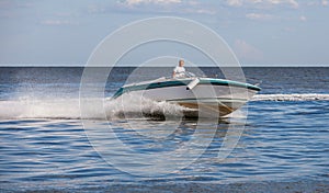 Man driving a fast boat