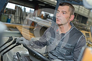 Man driving forklift inside warehouse