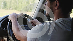 Man driving his car. Driving car at holiday. Male hand on steering wheel close-up