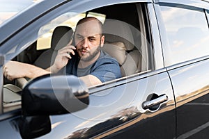 Man driving his car speaking on the cellphone. transportation and vehicle