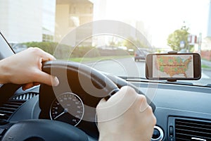 Man driving his car using his mobile gps