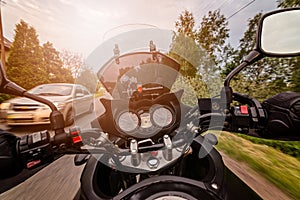 Man driving his motorcycle on asphalt country road