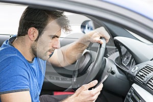 Man driving and looking message in his smart phone