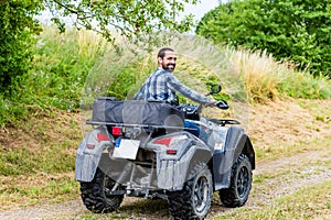 Man driving off-road with quad bike
