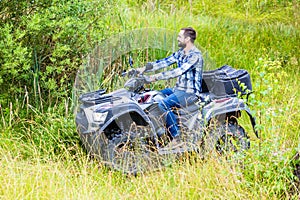 Man driving off-road with quad bike