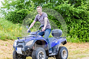 Man driving off-road with quad bike