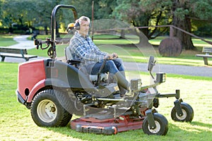 Man driving professional mower