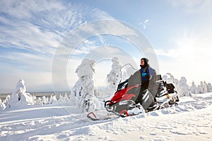 Man driving snowmobile in Finland photo