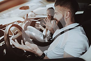 Man Is Driving A Tesla Car. Girl At Front Seat.