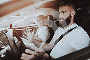 Man Is Driving A Tesla Car. Girl At Front Seat