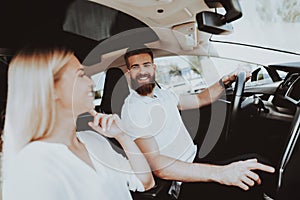 Man Is Driving A Tesla Car. Girl At Front Seat