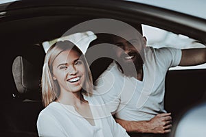 Man Is Driving A Tesla Car. Girl At Front Seat