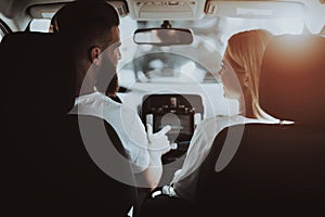 Man Is Driving A Tesla Car. Girl At Front Seat