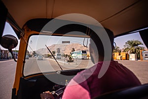 Man driving TukTuk Vehicle near Luxor Temple in Egypt