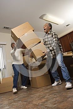 Man Dropping Stack of Boxes photo