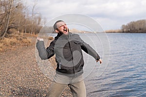 Man dropping a stone into the river