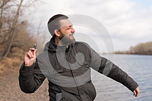 Man dropping a stone into the river