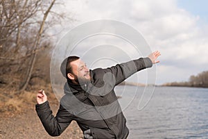 Man dropping a stone into the river